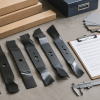 Generic mower blades, calipers, packaging boxes, and a buyer data checklist on a worktable