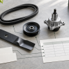 Editorial flat lay of generic mower replacement parts, blank data cards, and a catalog mapping grid